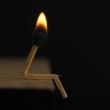Lighted Matchstick on Brown Wooden